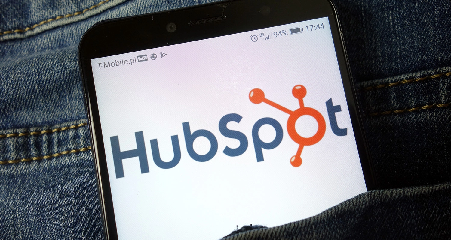 telefono movil con la imagen del logo de hubspot en un bolsillo